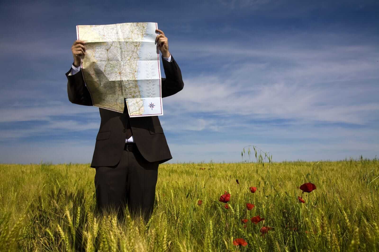 Businessman lost in a field by Ana de Sousa via Shutterstock