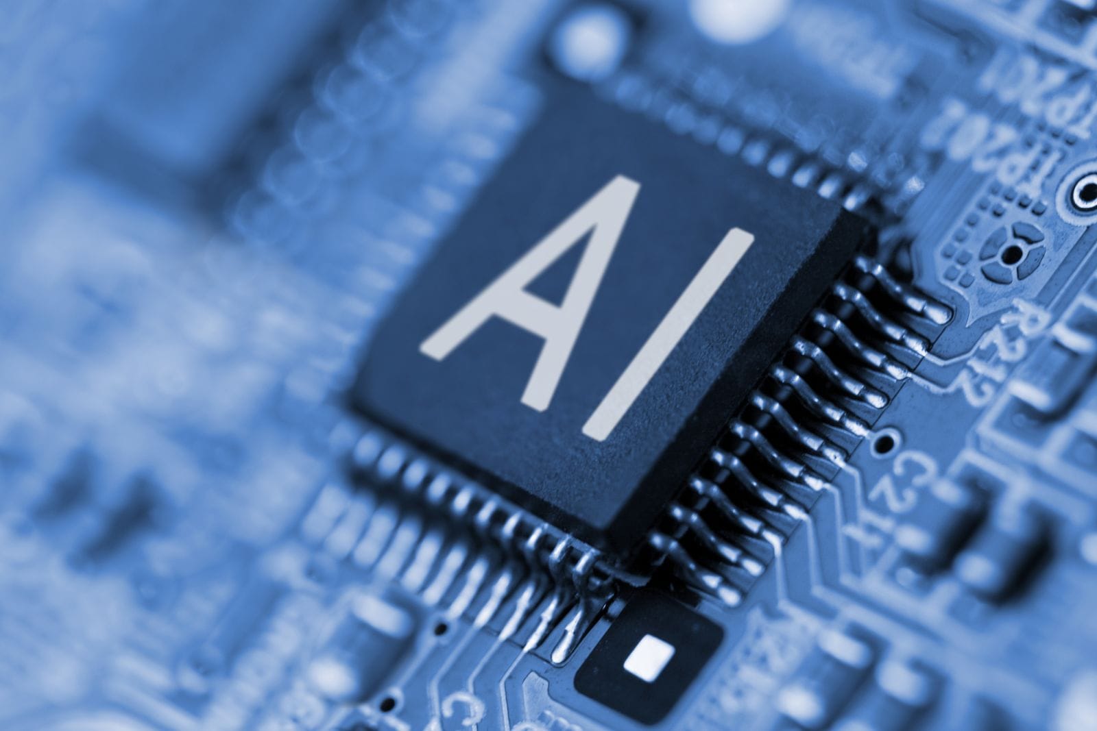 Close- up of computer chip with AI sign by YAKOBCHUK V via Shutterstock