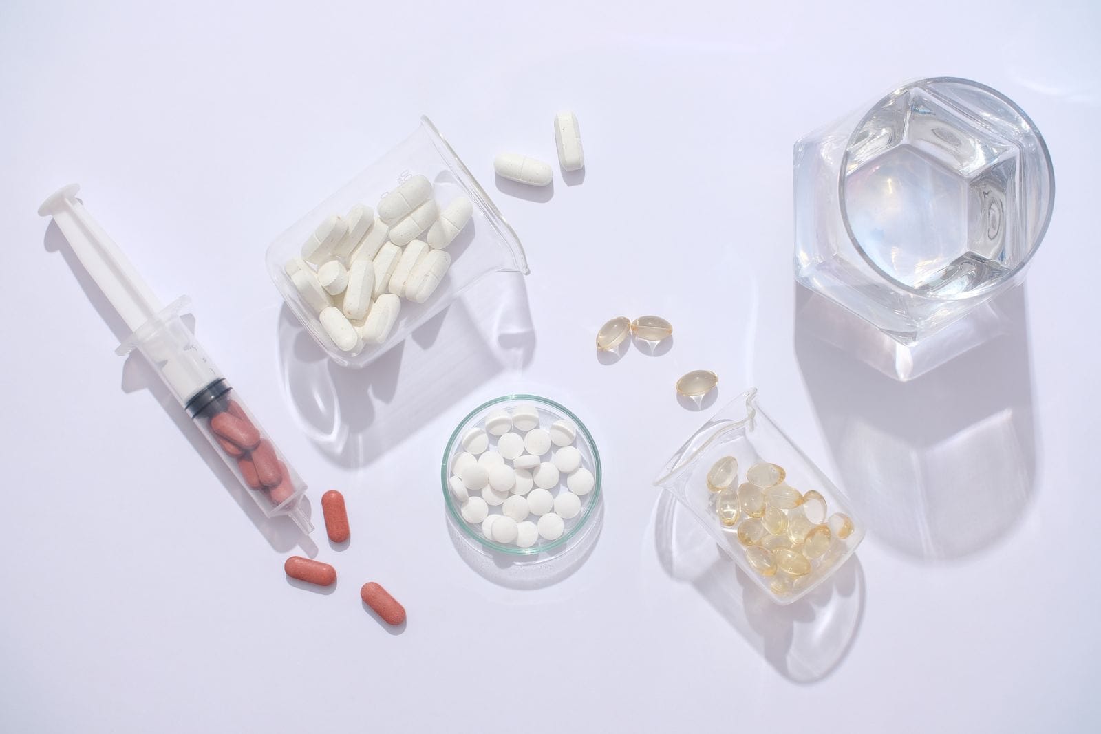 pills in a petri dish and syringe by LightStock via iStock