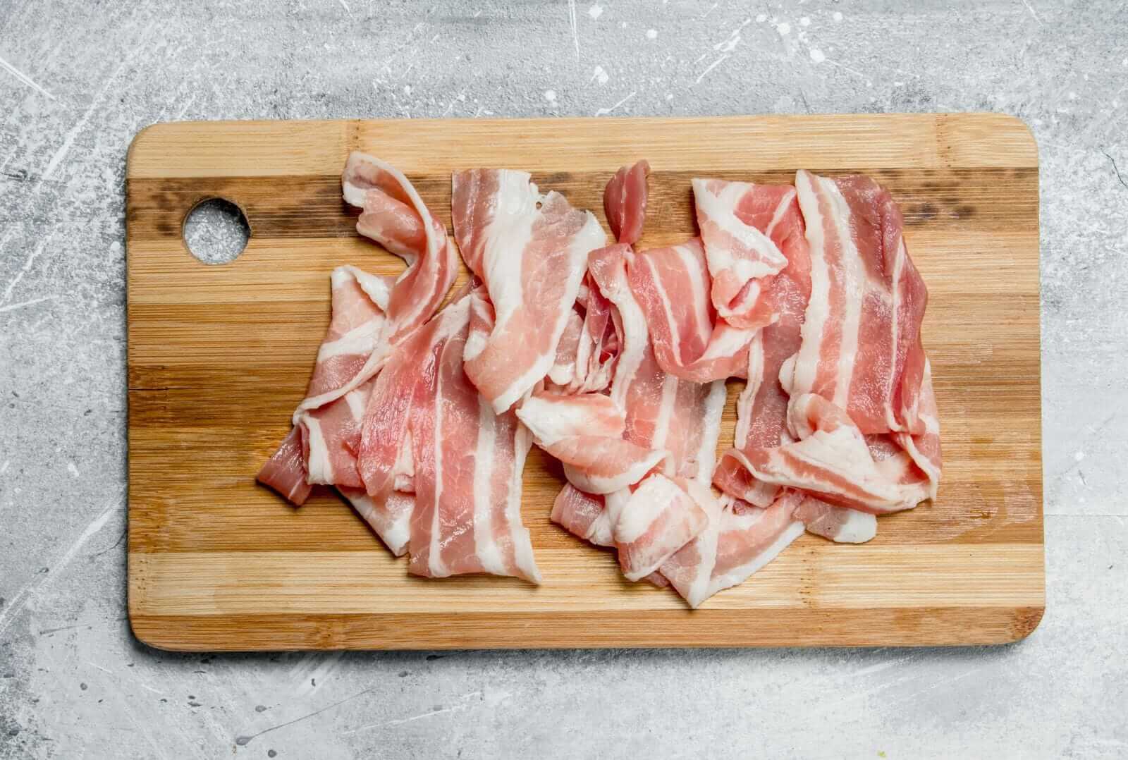 Pork bacon on a cutting board by Olesia Shadrina via iStock