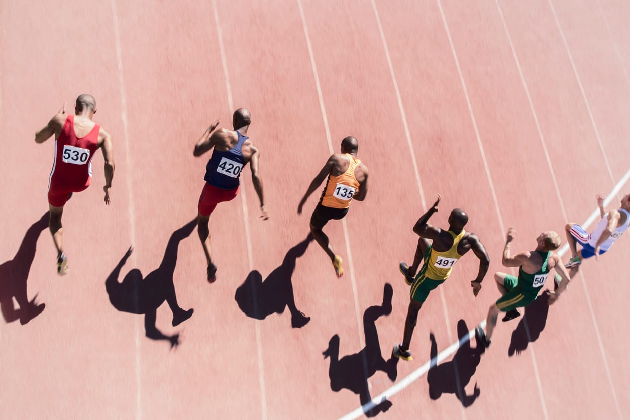 Runners racing on a track by Tom Merton via iStock
